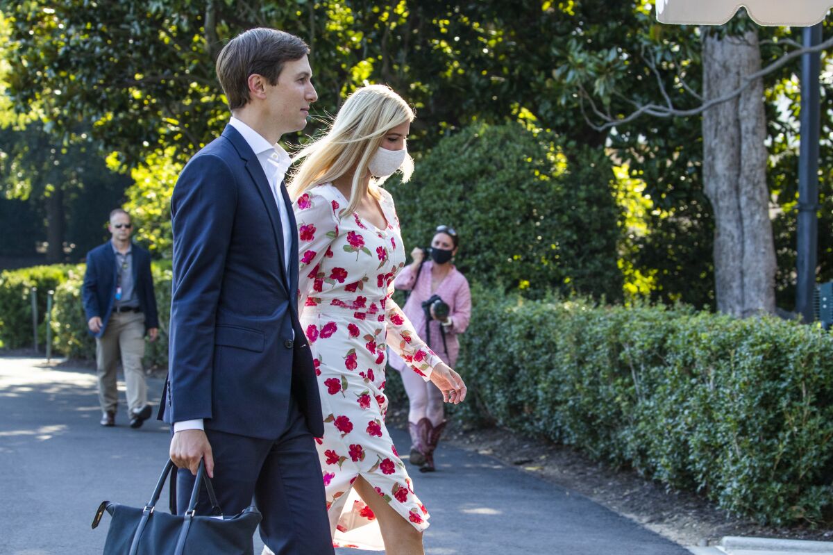 Ivanka Trump, right, daughter of and adviser to President Donald Trump, and White House senior adviser Jared Kushner walk on the South Lawn after they arrived with the president at the White House, Sunday, July 26, 2020, in Washington. (AP Photo/Manuel Balce Ceneta)