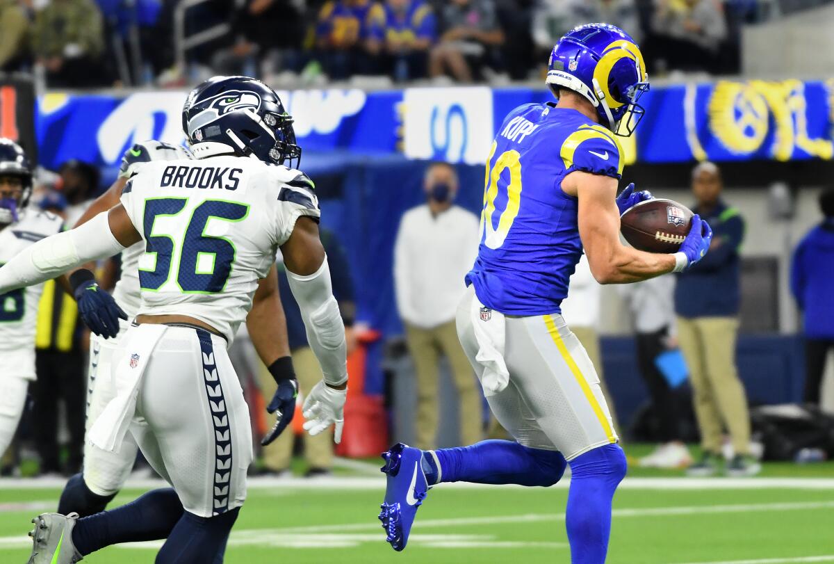 Rams receiver Cooper Kupp runs past Seahawks linebacker Jordyn Brooks for the  touchdown reception.