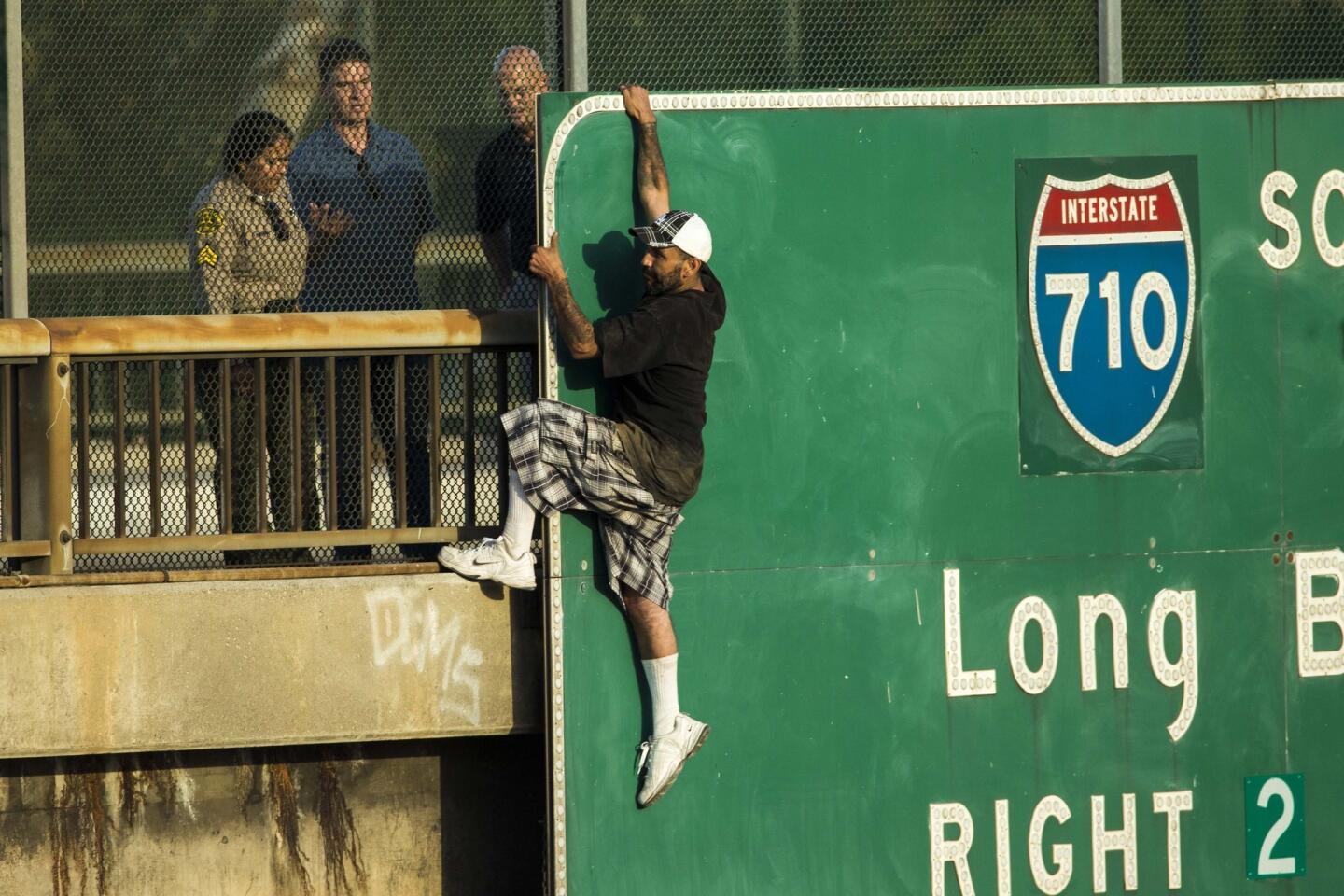 Man hangs from sign above 5 Freeway