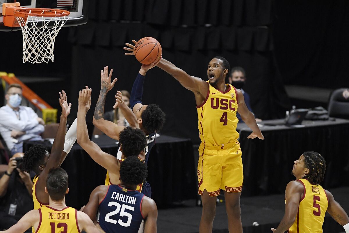 Southern California's Evan Mobley (4) blocks a shot by Connecticut's James Bouknight during the second half of an NCAA college basketball game Thursday, Dec. 3, 2020, in Uncasville, Conn. (AP Photo/Jessica Hill)