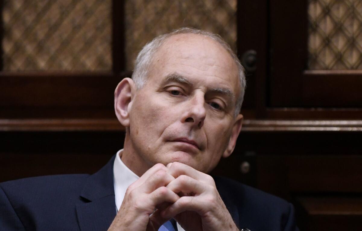 White House Chief of Staff John Kelly listens to President Trump during a working lunch with governors at the White House on June 21.