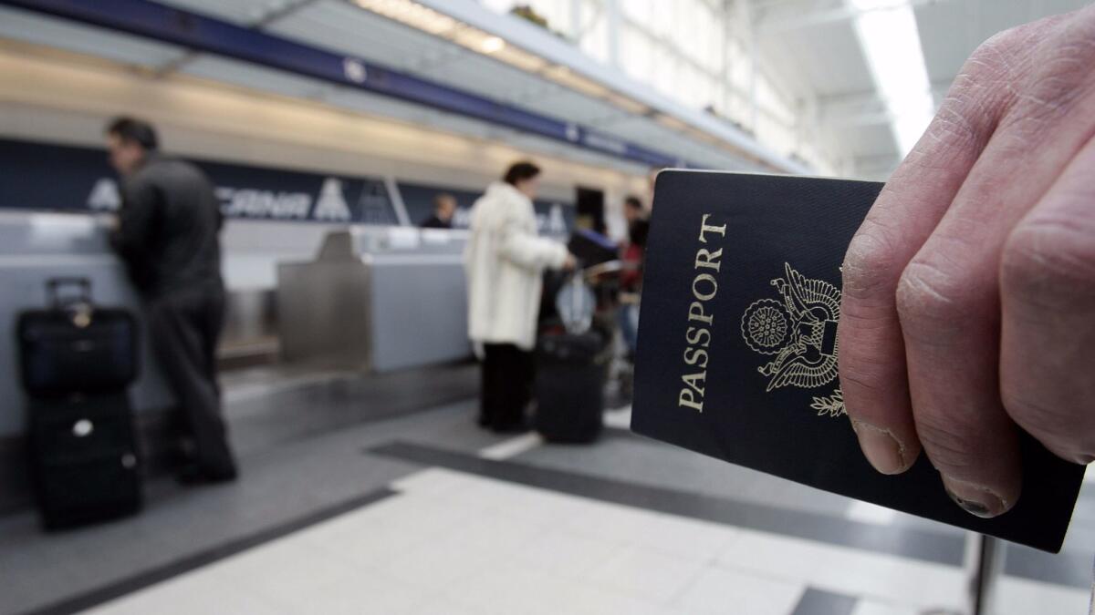 A passenger waits in line with his passport.