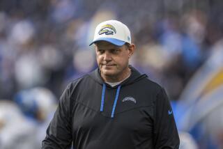 Los Angeles Chargers outside linebackers coach Giff Smith walks on the field before an NFL football game against the Los Angeles Rams, Sunday, Jan. 1, 2023, in Inglewood, Calif. (AP Photo/Kyusung Gong)