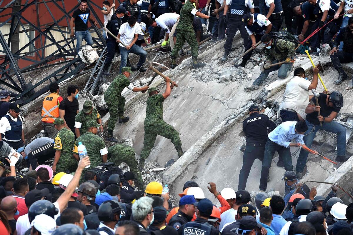 Rescuers, firefighters, police officers, soldiers and volunteers remove rubble and debris from a flattened building in search of survivors after a powerful quake in Mexico City.