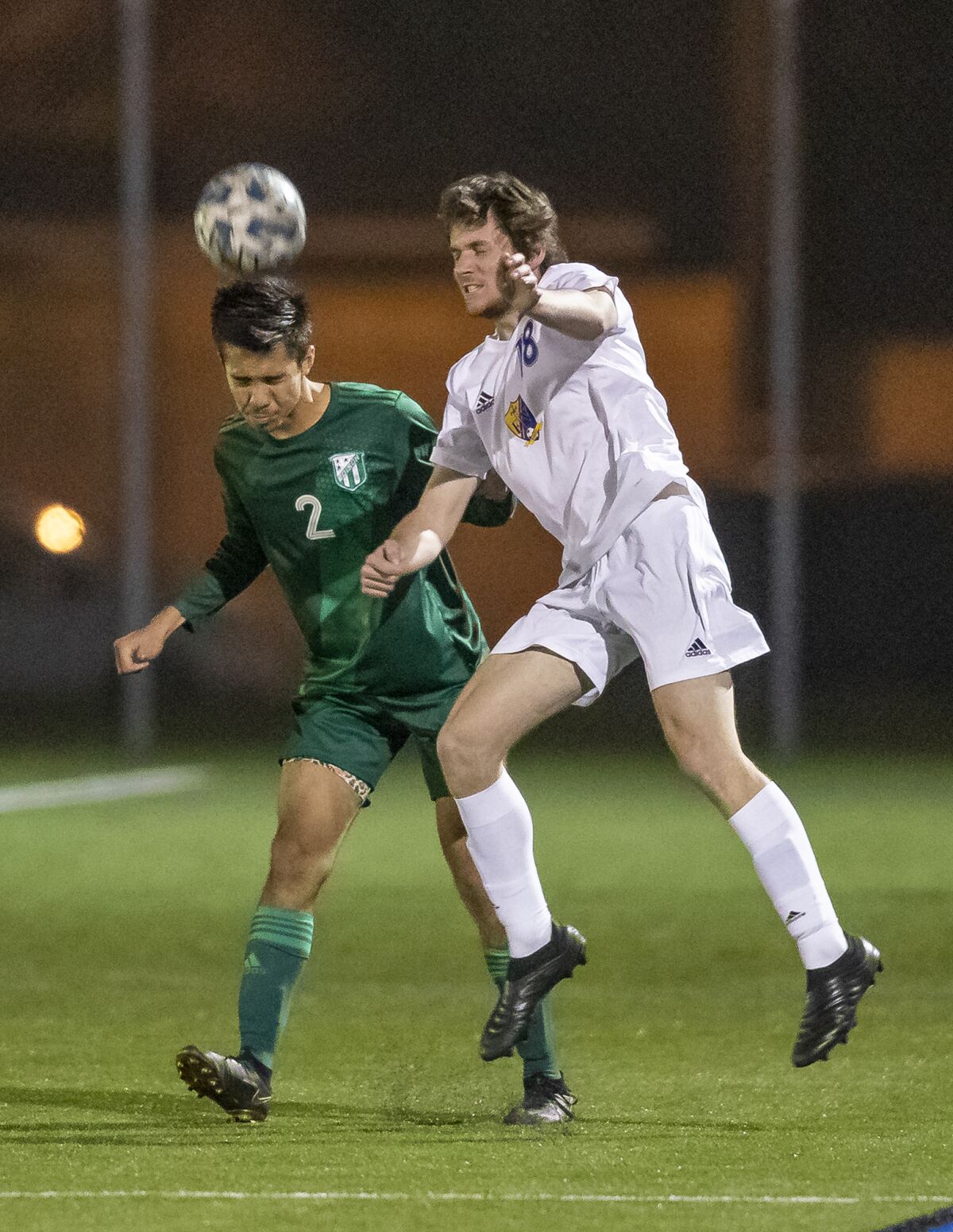 Edison's Nathan Peterson and Fountain Valley's Parker Kendig go up for a header during a Surf League boys' soccer match.