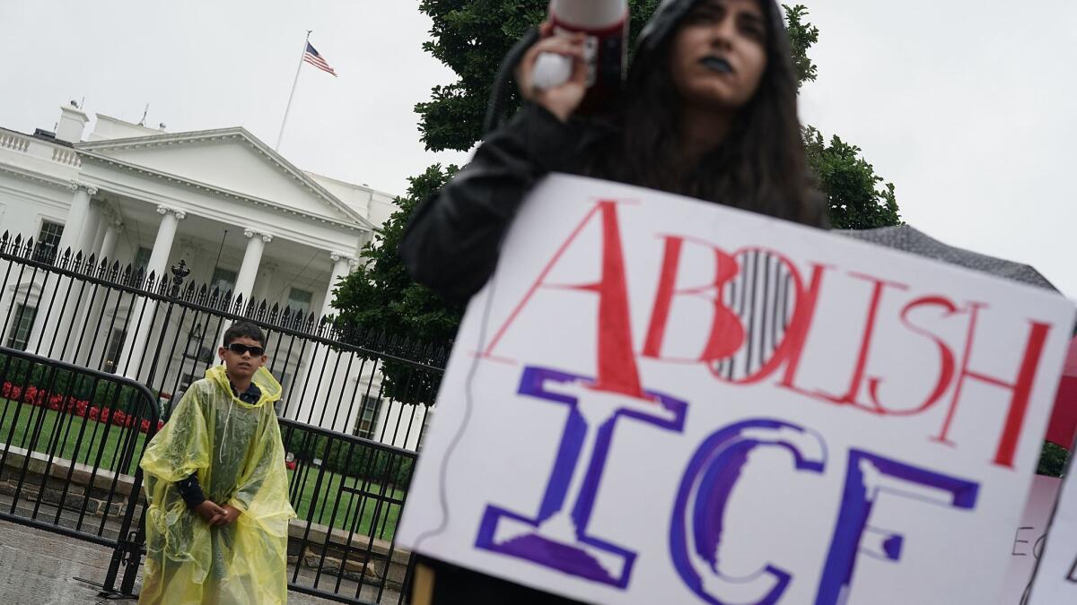 An immigrant rights activist protests outside the White House on June 22.