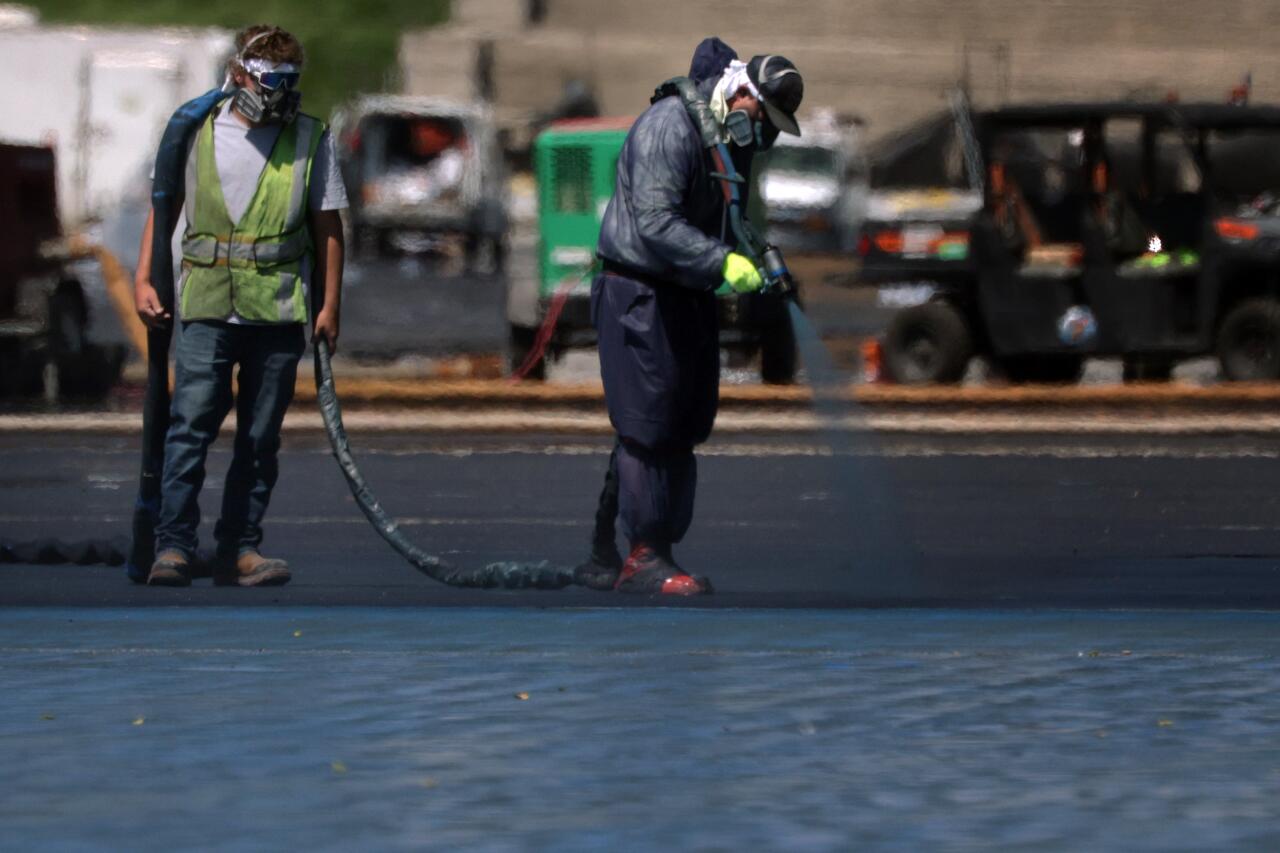 Workers painting a pool.