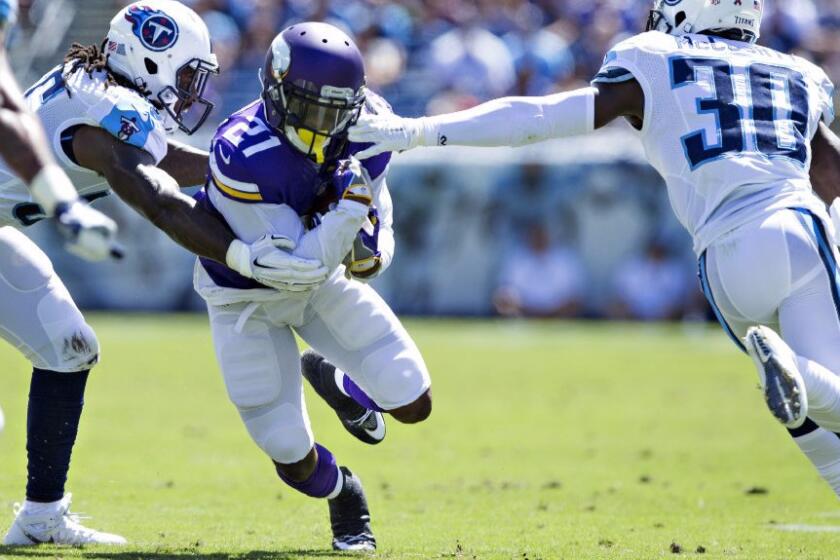 Vikings running back Jerick McKinnon carries the ball against the Titans during an exhibition game on Sept. 11.