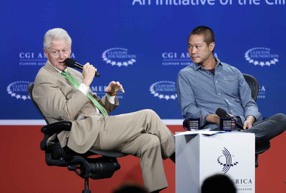 Former President Bill Clinton speaks with Zappos.com CEO Tony Hsieh 