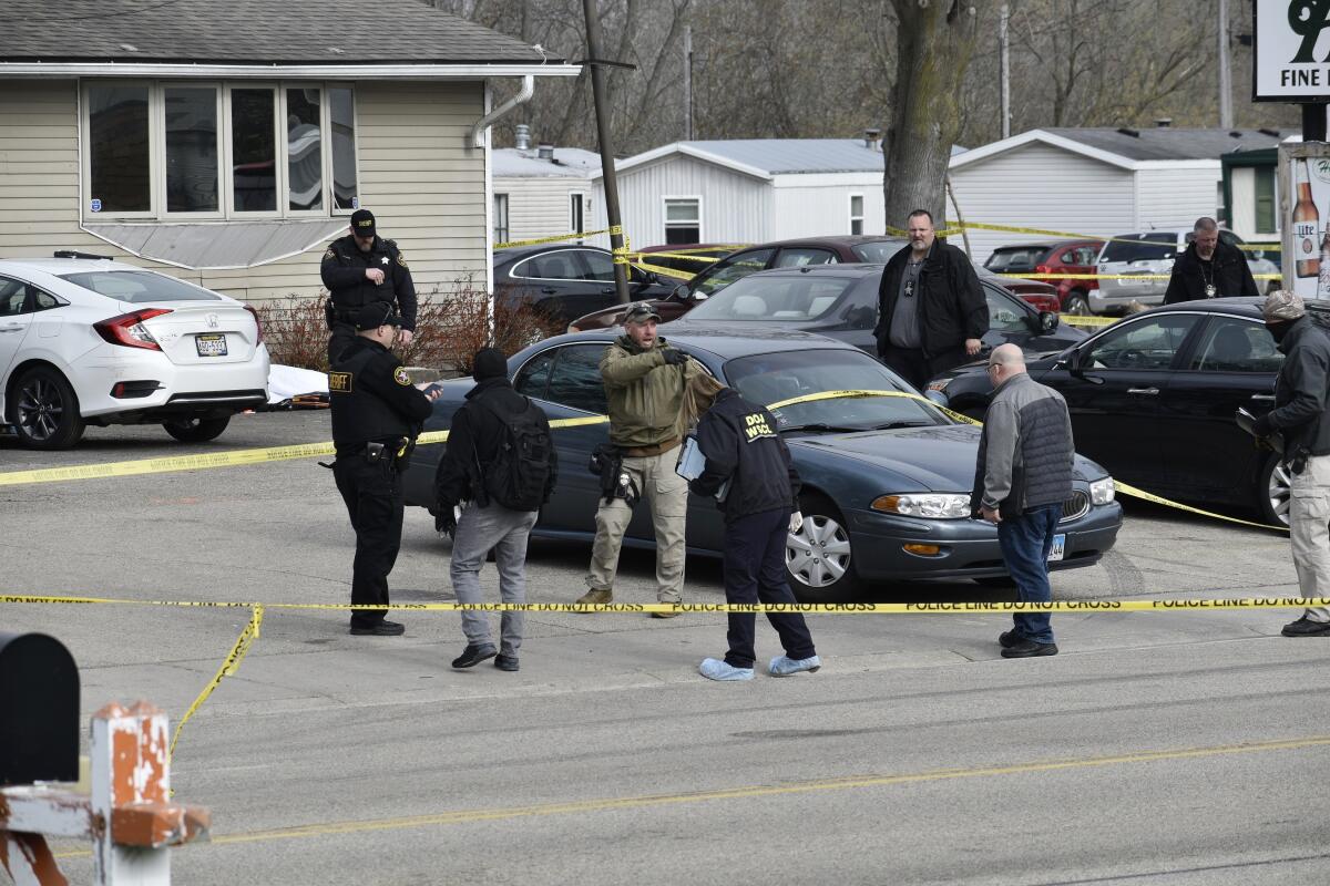 Investigators inside an area blocked off by crime scene tape