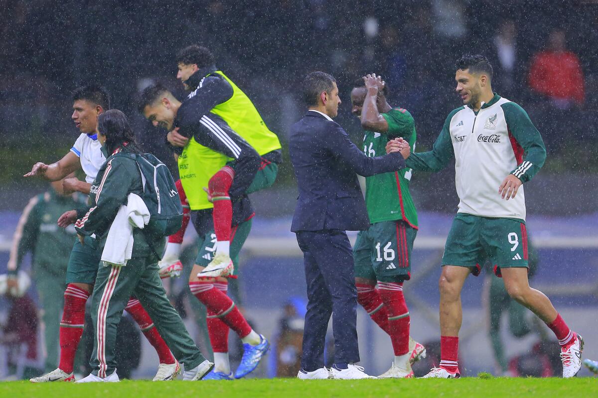 Mexico coach Jaime Lozano congratulates Raul Jimenez, right, after a win over Honduras in the CONCACAF Nations League.