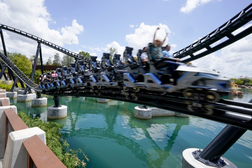 Guests try out the new Jurasic World VelociCoaster during a media preview at Universal Studios theme park Wednesday, June 9, 2021, in Orlando, Fla. The roller coaster will open to the public Thursday. (AP Photo/John Raoux)