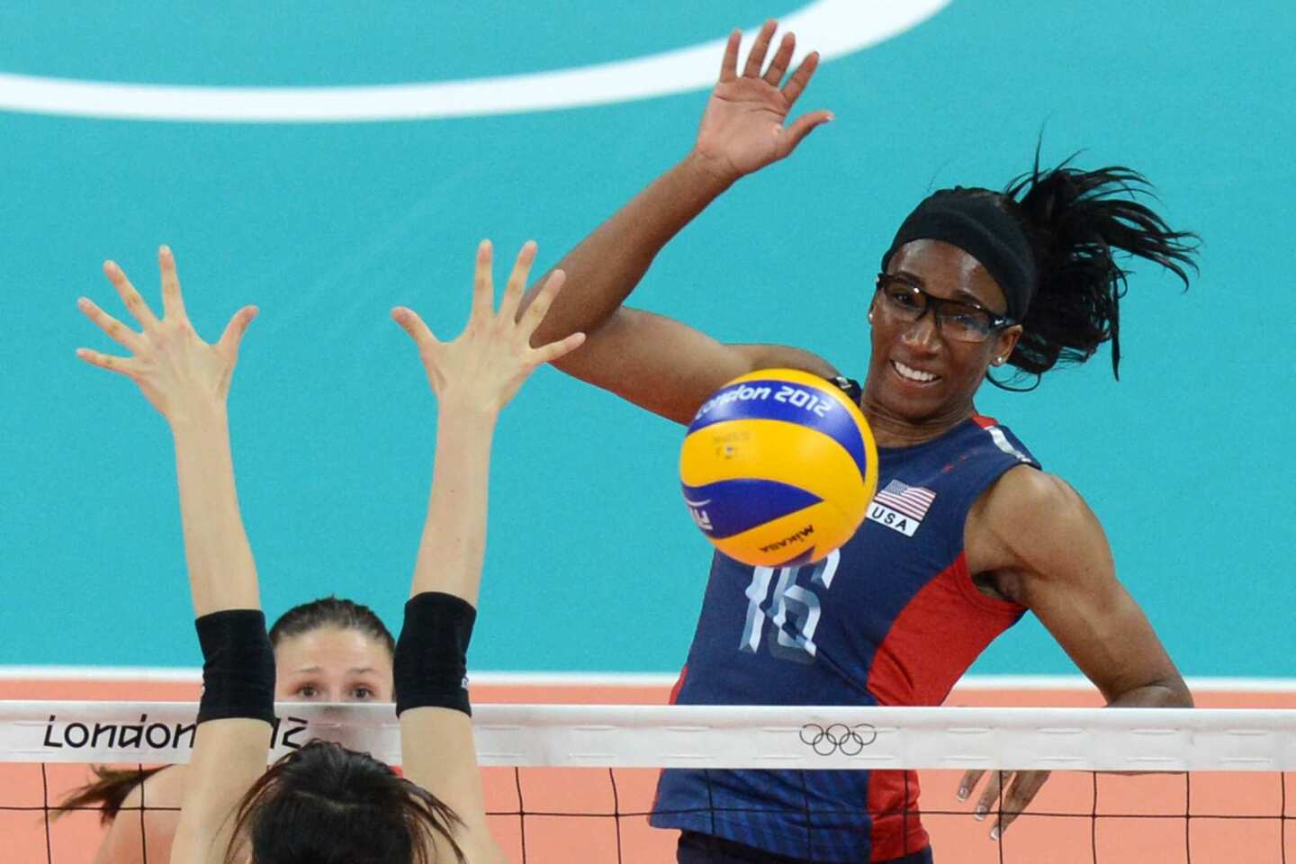 Foluke Akinradewo of the United States spikes ball in the women's volleyball match against South Korea.