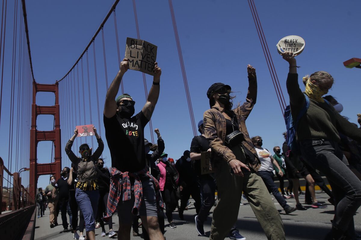 People march on the Golden Gate Bridge in San Francisco as part of a June 6 protest over the death of George Floyd.