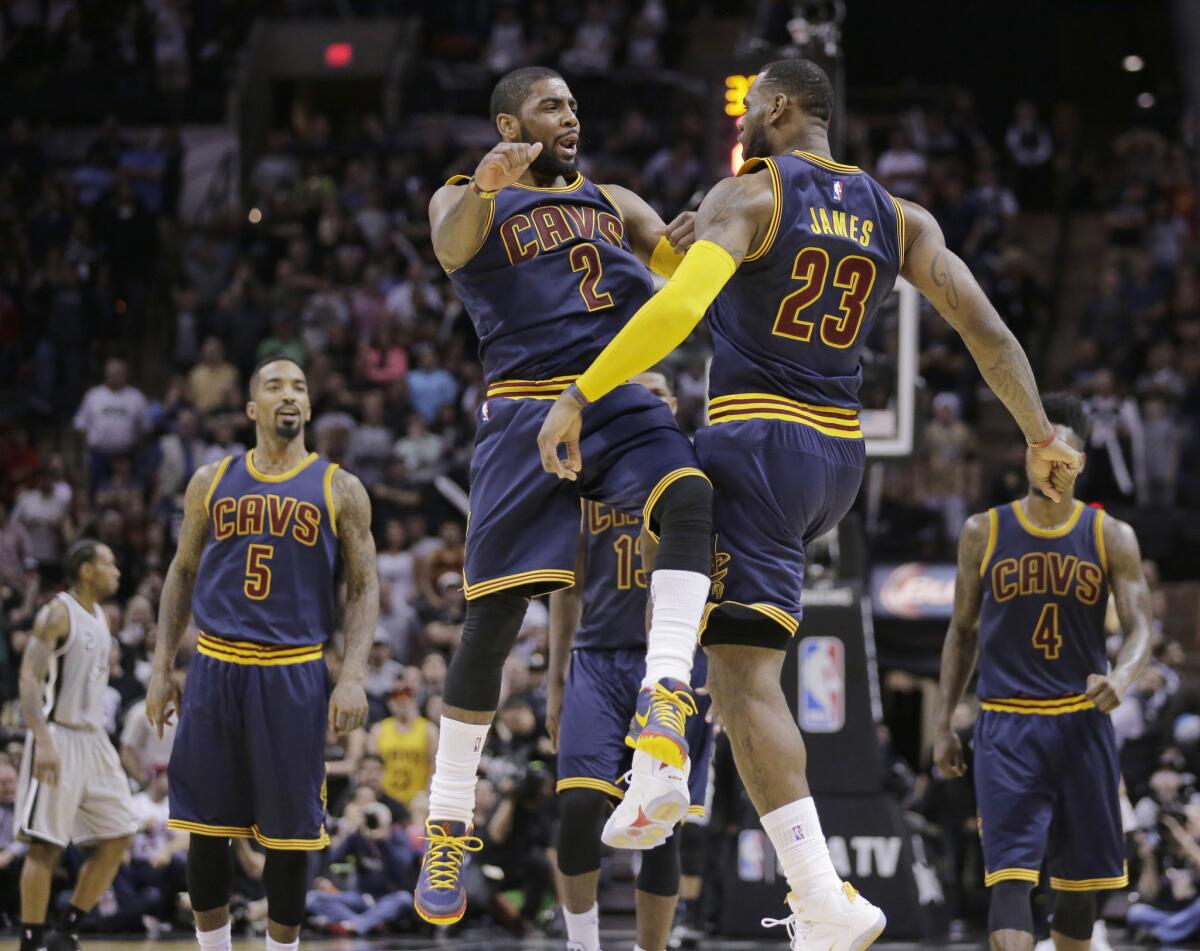 Cavaliers point guard Kyrie Irving and forward LeBron James celebrate during the Cavaliers' 128-125 overtime win over the Spurs.