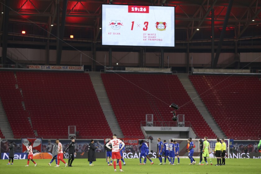A view of an empty stadium, at the end of the German Bundesliga soccer match between RB Leipzig and Bayer Leverkusen, at the Red Bull Arena in Leipzig, Germany, Sunday, Nov. 28, 2021. The Bundesliga held its first game for months without fans. (Jan Woitas/dpa via AP)