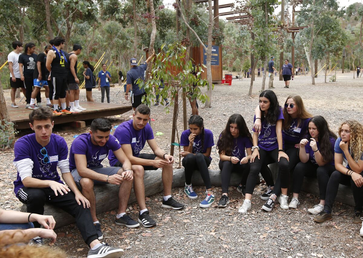 Israeli, Palestinian and American teens prepare for a team-building event on the high-wire Challenge Course at UC San Diego on Sunday during the annual three-week Hands of Peace summit. The Carlsbad program brings the next generation of leaders together for often-contentious dialogues and reconciliation on the political and religious issues that divide them.