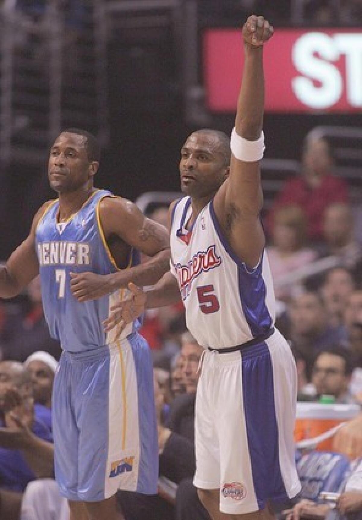 Clipper guard Cuttino Mobley, right, throws a fist in the air after hitting a three-pointer during first quarter of Monday's 101-83 victory over the Denver Nuggets at Staples Center.