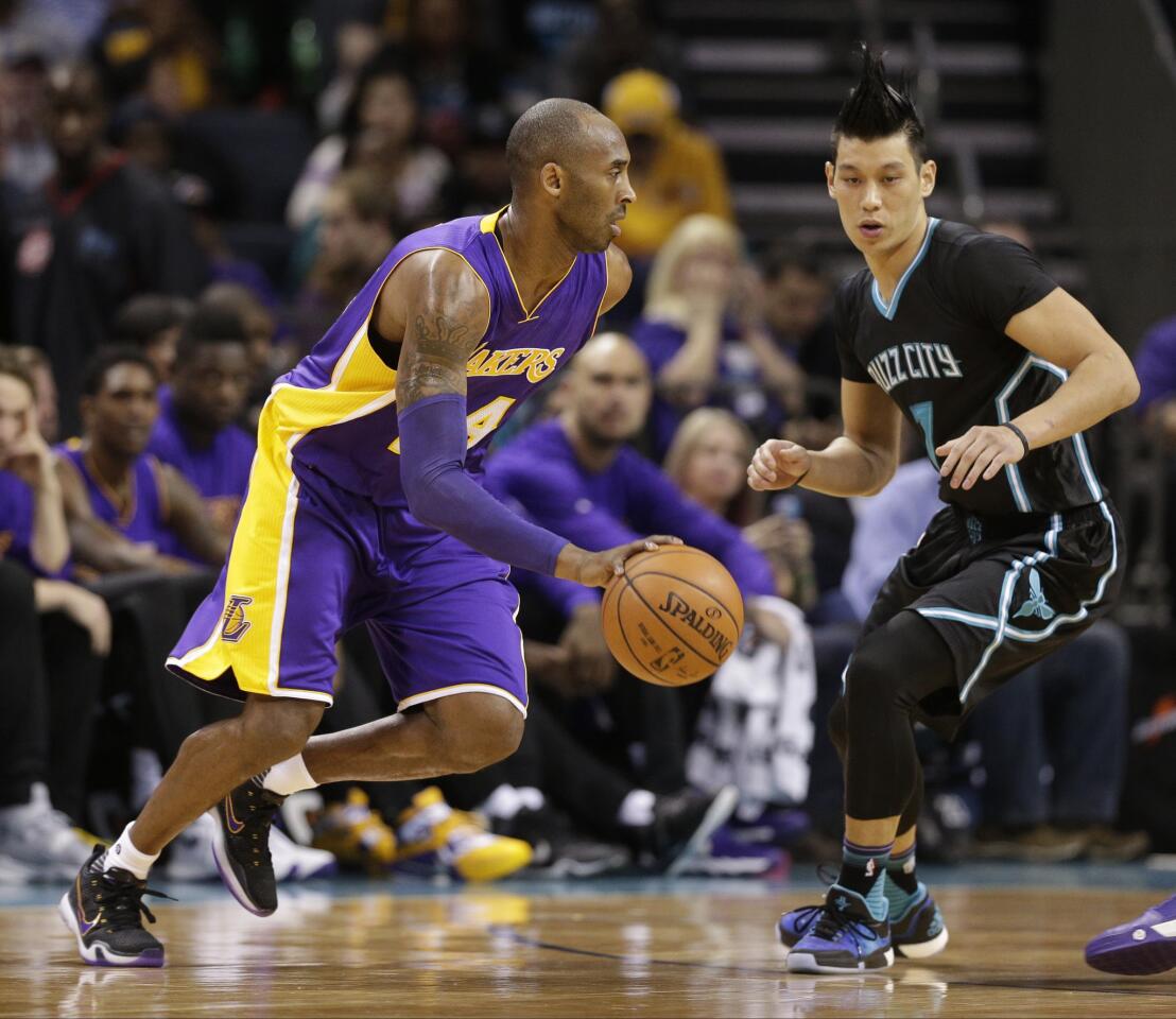 Lakers forward Kobe Bryant (24) drives against Hornets guard Jeremy Lin (7) in the first half.