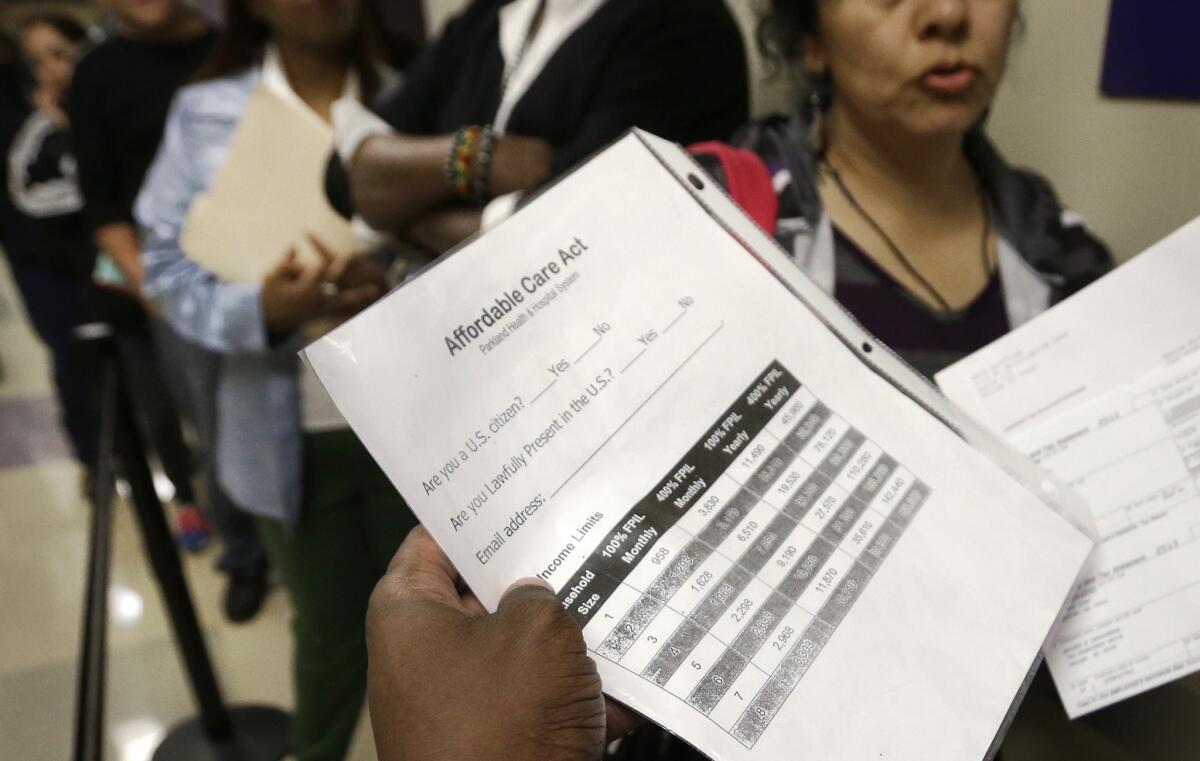 People wait to sign up for health insurance in July at Parkland Hospital in Dallas, the city's large public hospital.