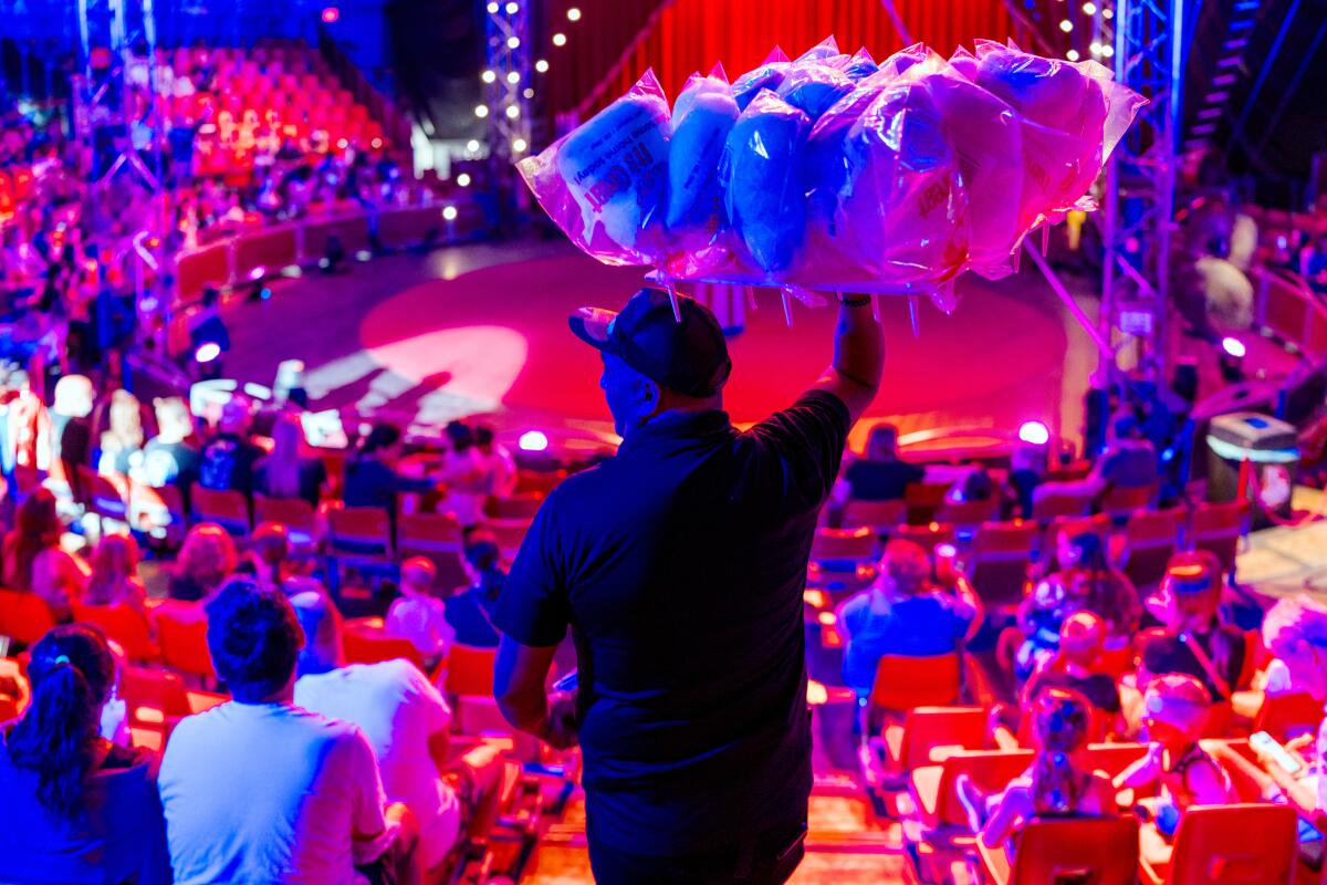 A vendor sells cotton candy before the performances begin.