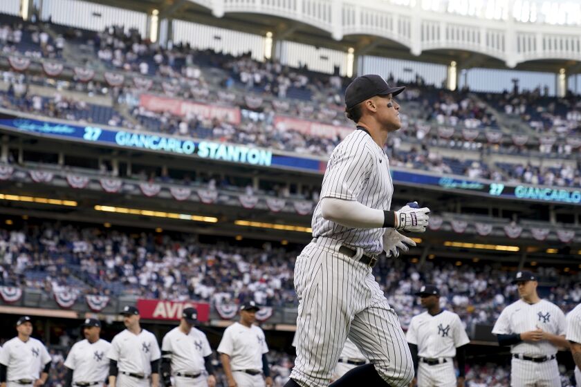 New York Yankees right fielder Aaron Judge runs onto the field during player introductions before Game 3 of an American League Championship baseball series against the Houston Astros, Saturday, Oct. 22, 2022, in New York. (AP Photo/John Minchillo)