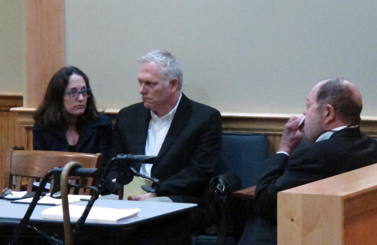 Film director Randall Miller, center, sits in a Georgia courtroom with his wife, Jody Savin before pleading guilty to charges of involuntary manslaughter and criminal trespassing.