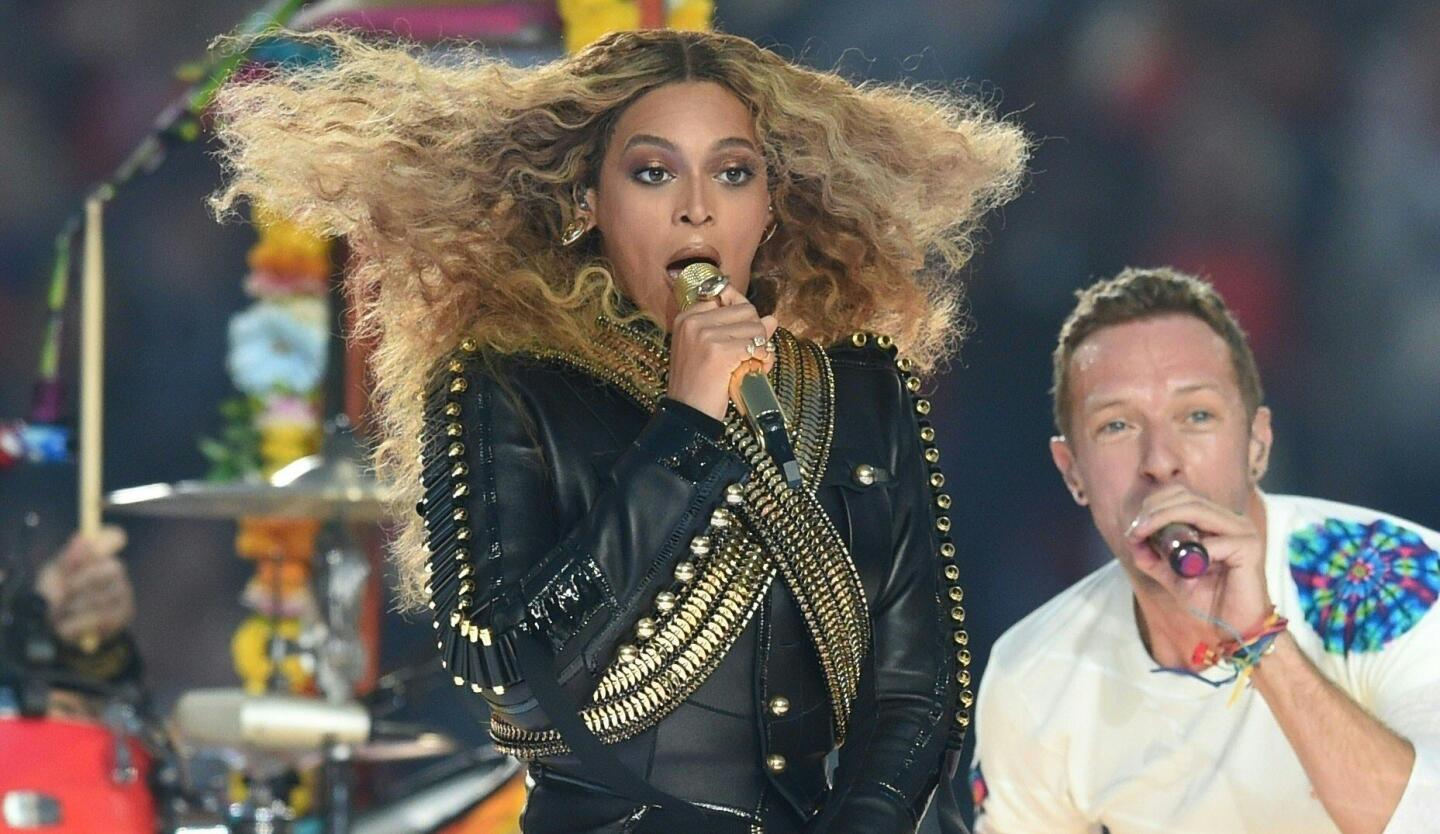 Beyonce and Chris Martin perform during Super Bowl 50 between the Carolina Panthers and the Denver Broncos at Levi's Stadium. TIMOTHY A. CLARY/AFP/Getty Images