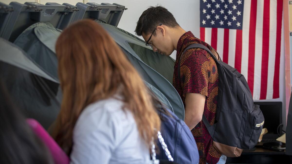 People cast their ballots for the midterm elections at the early voting center at the University of California Irvine campus in Irvine, Calif. on Oct. 30.