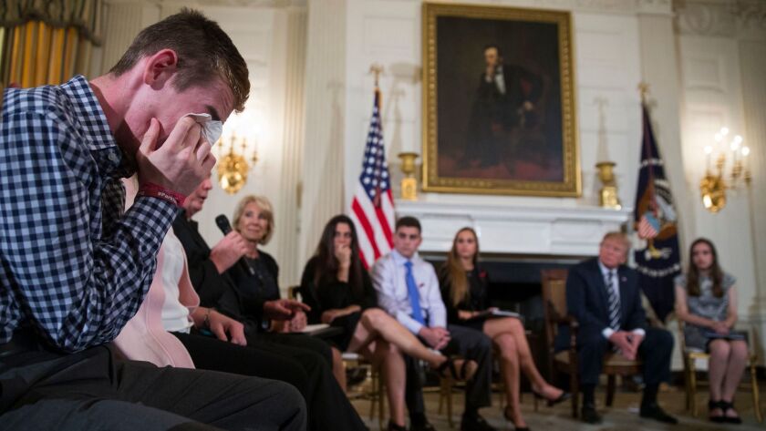 Marjory Stoneman Douglas High School shooting survivor Samuel Zeif, left, cries after delivering remarks to President Trump and others at a White House listening session.