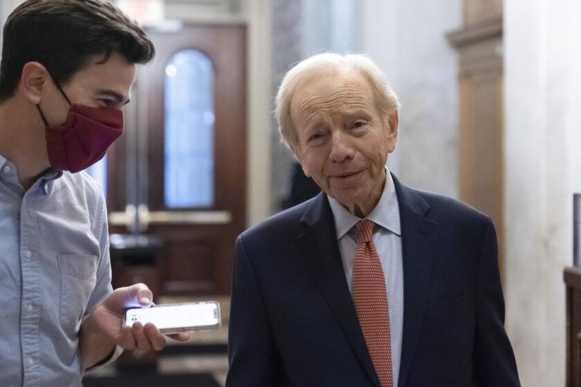 FILE - Former Sen. Joe Lieberman of Conn., right, speaks with a reporter at the Capitol in Washington, June 22, 2021. A funeral for Lieberman will be held Friday, March 29, 2024, in his hometown of Stamford, Conn. Lieberman died in New York City on Wednesday, March 27, at age 82. (AP Photo/Alex Brandon, File)