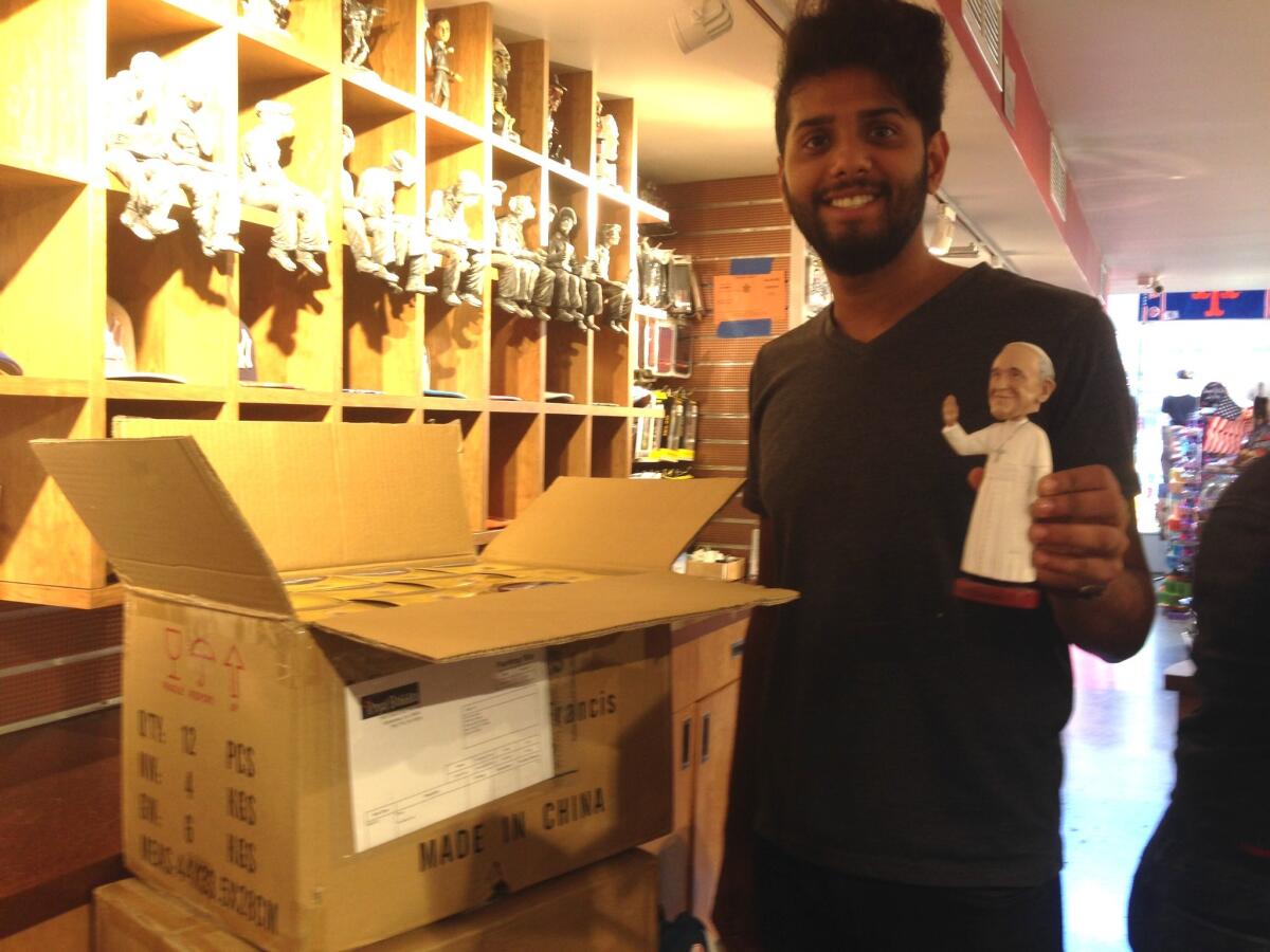 Samir Sabir, at City Souvenirs in Manhattan, opens a fresh supply of bobblehead Pope Francis dolls, which are scarce in New York City.