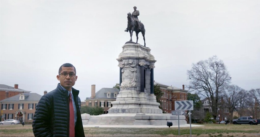 A man stands in front of a Confederate statue in the documentary “The Neutral Ground.”
