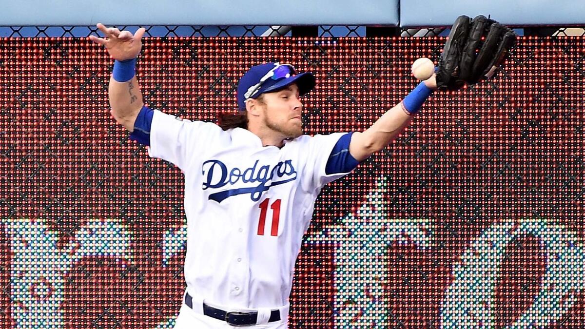 Dodgers right fielder Josh Reddick leaps but can't make the catch on a two-run double by Nationals Ryan Zimmerman in the ninth inning.