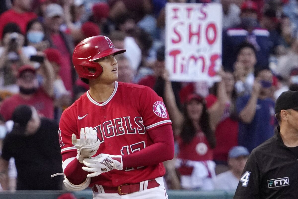 Angels star Shohei Ohtani reacts to hitting a triple against the Seattle Mariners.