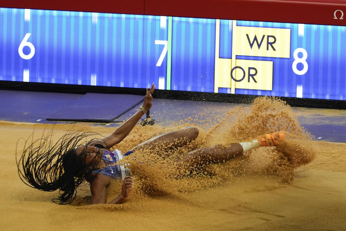 Tara Davis-Woodhall competes in the women's long jump final.