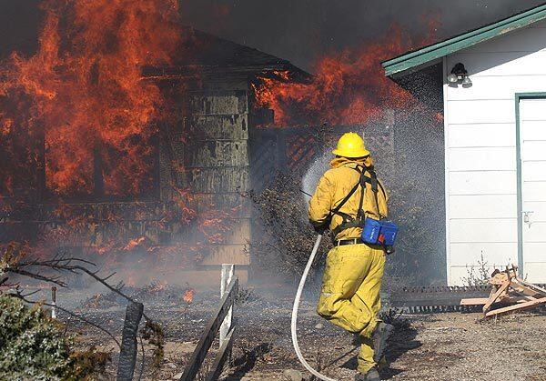 Firefighters battle Caughlin Fire in south Reno, Nev., on Friday.