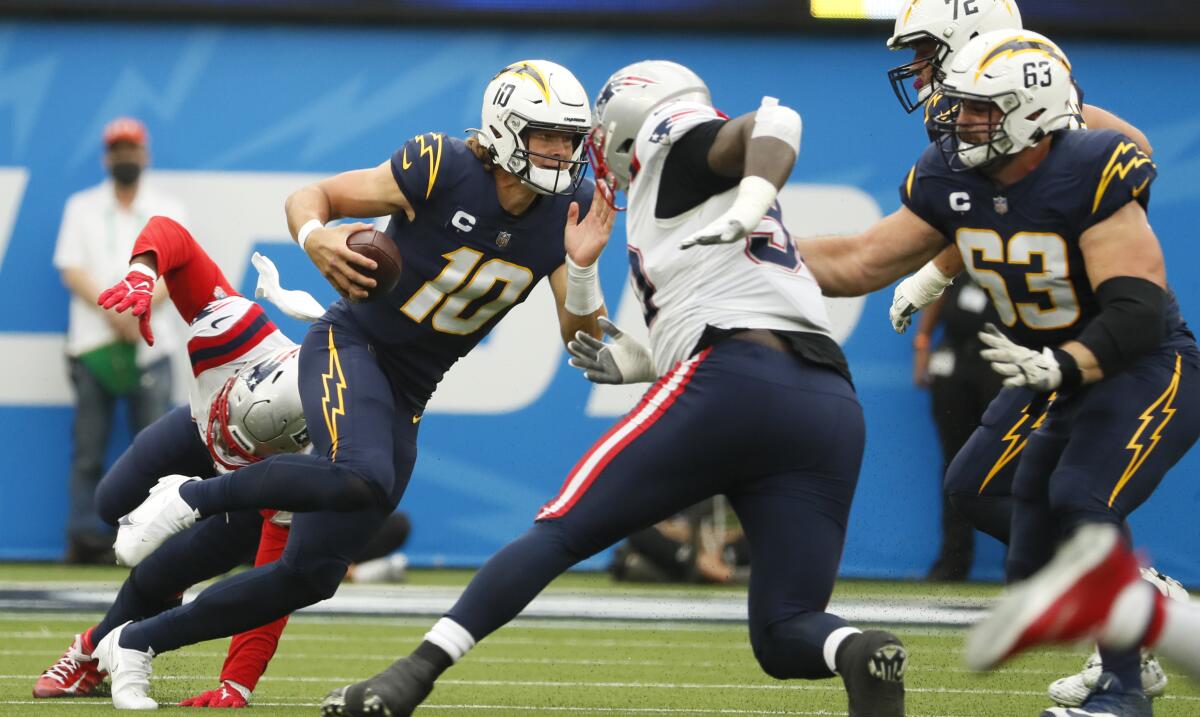 Chargers quarterback Justin Herbert runs with the ball against the New England Patriots on Sunday.