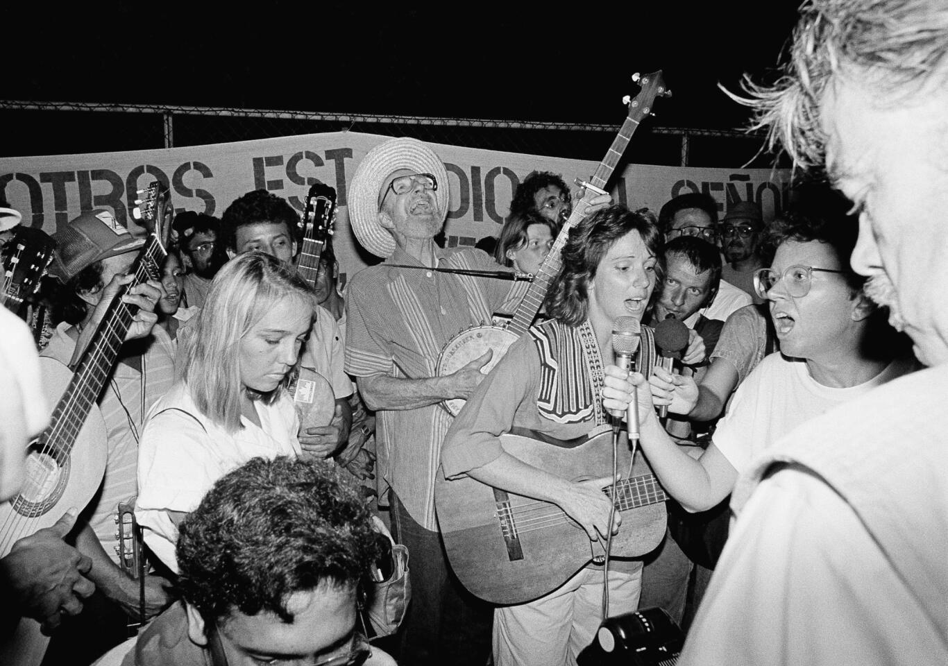 Seeger joins in a song at a 1988 rally outside the U.S. Embassy in Managua, Nicaragua. The gathering was to protest U.S. aid going to the Nicaraguan Contra rebels.