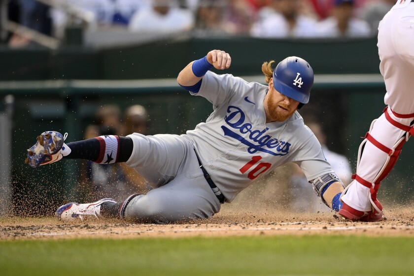 Justin Turner slides to score on a sacrifice fly against the Nationals.