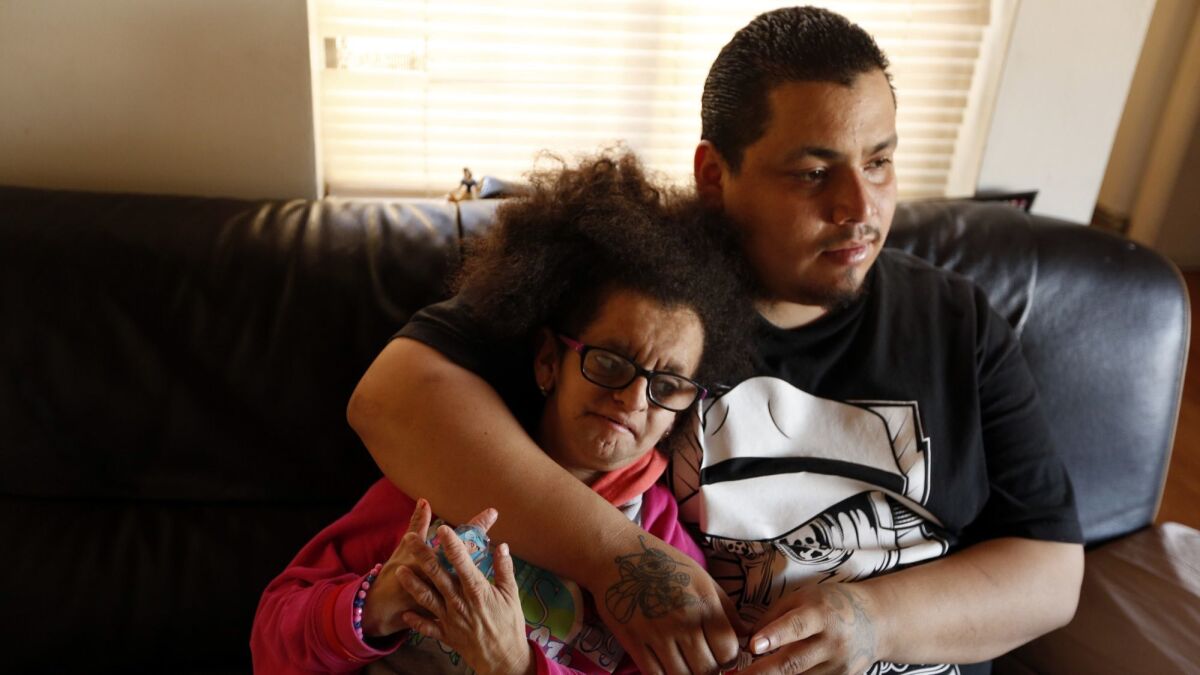 Jesus Arreola Robles, then 22, spends time with his sister, Maria Lupita Arreola, then 16, who has the accelerated aging disorder progeria, in their family's North Hollywood apartment on March 15, 2017.