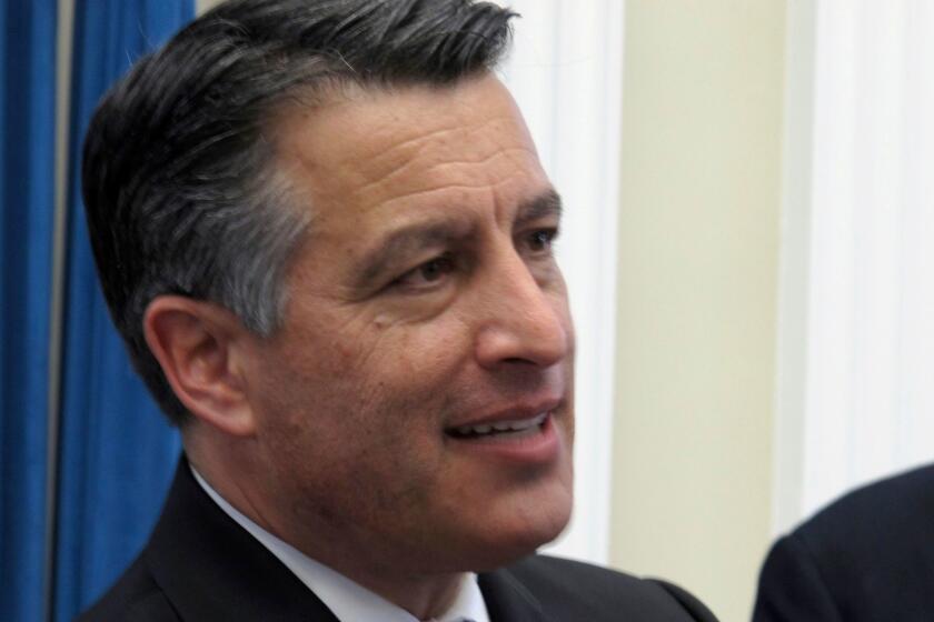 Nevada Republican Gov. Brian Sandoval listens to a reporter's question after signing a series of budget bills Monday, June 5, 2017, in the Old Assembly Chambers at the state Capitol in Carson City, Nev. (AP Photo/Scott Sonner)