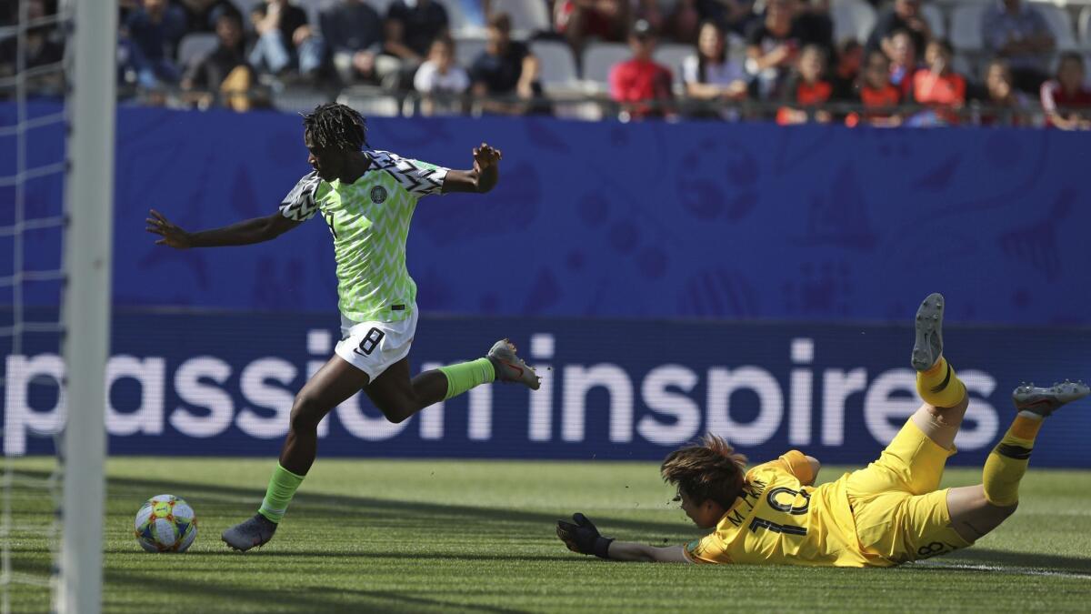 Nigeria's Asisat Oshoala gets past South Korea goalkeeper Kim Min-jung on her way to scoring her team's second goal during a Women's World Cup Group A match Wednesday in Grenoble, France.