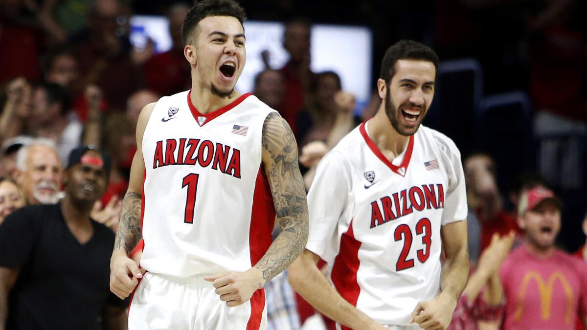 Arizona guard Gabe York (1) celebrates with teammate Mark Tollefsen after helping the Wildcats defeat California on Thursday night.