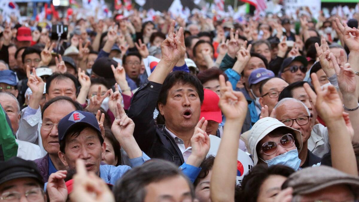 Supporters of South Korean presidential candidate Hong Joon-pyo of the Liberty Korea Party shout his name during a campaign rally in Seoul on Monday.