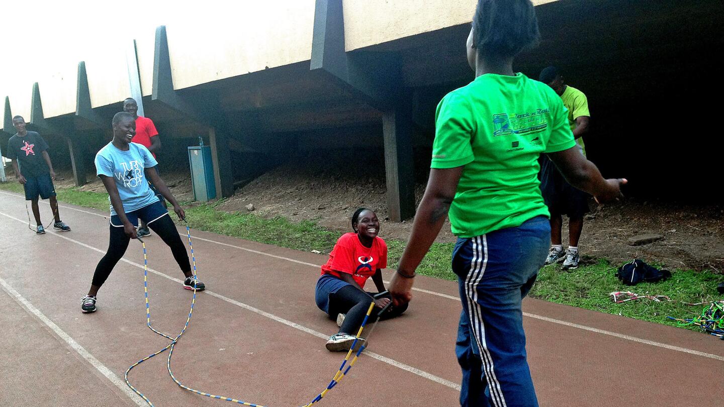 Beryl Atieno, left, and teammates laugh during practice in Nairobi, Kenya. At first, her family didn't understand her fascination with jumping rope. "I was not interested," her mother said. "She did not have time to help me cook or wash dishes."