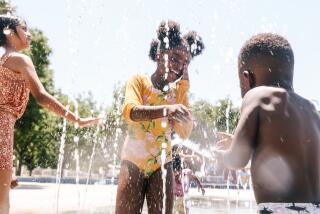 Lancaster, CA - July 07: Leela Finley Little, 6, cools off in the 110 degree weather at Tierra Bonita Park on Sunday, July 7, 2024 in Lancaster, CA. (Dania Maxwell / Los Angeles Times)