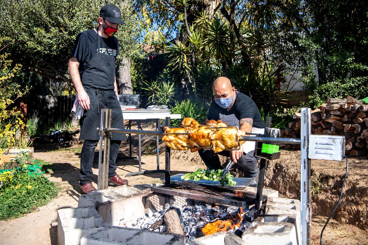 Chef Maynard Llera works the outdoor grill in his backyard in 2021, before opening his own restaurant.