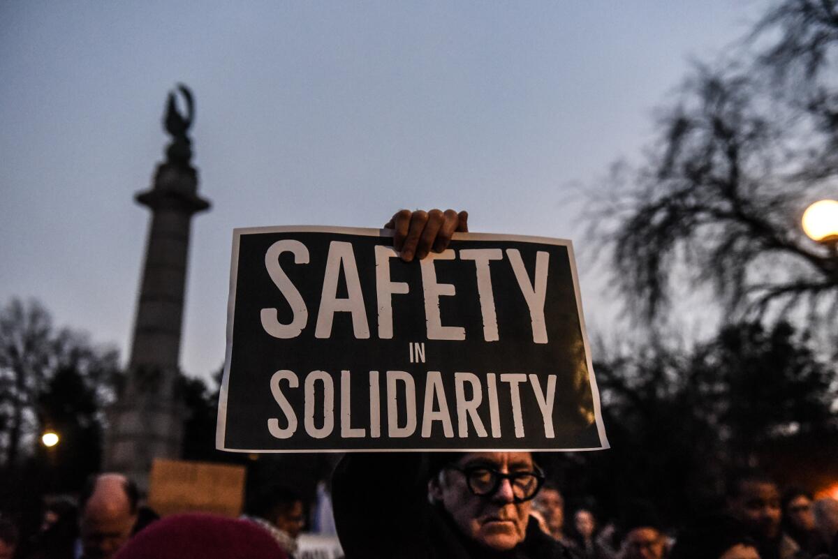 A demonstrator holds a sign at a #SafetyInSolidarity rally in Brooklyn, N.Y., on Tuesday in support of the Jewish community.