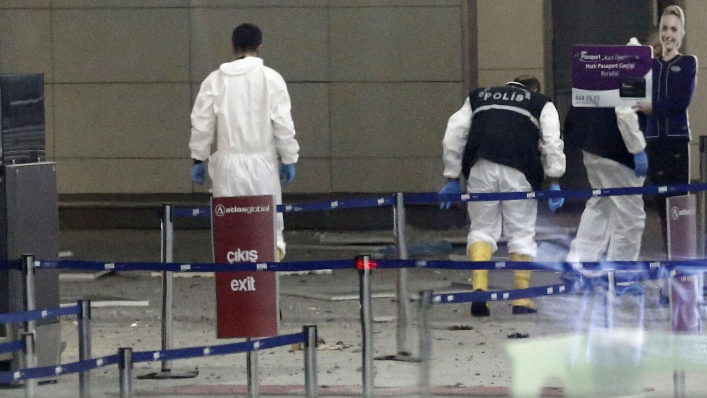 Police investigators look for evidence at Ataturk Airport in Istanbul.